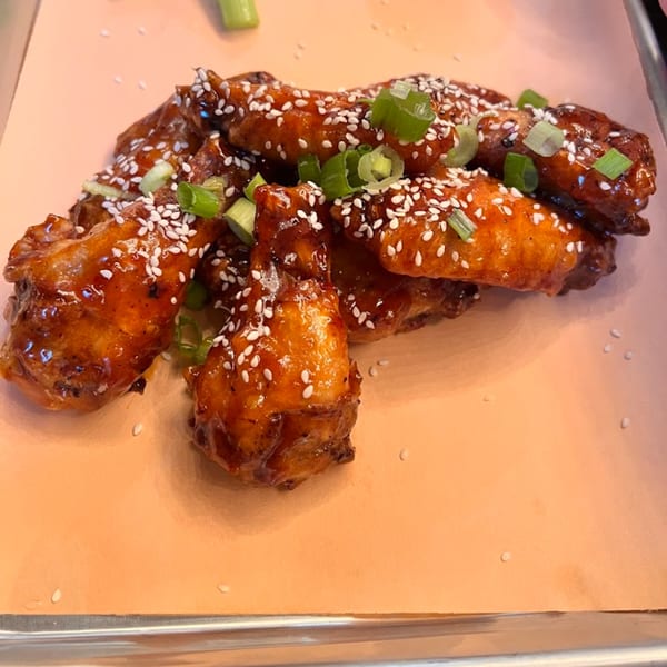 Runaway Train Brewery's sticky chicken wings, garnished with sesame seeds and green onions.
