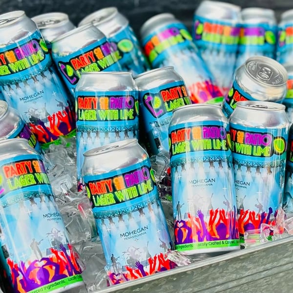 Runaway Train Brewery's Party Patio Lager with Lime cans chilling in ice.