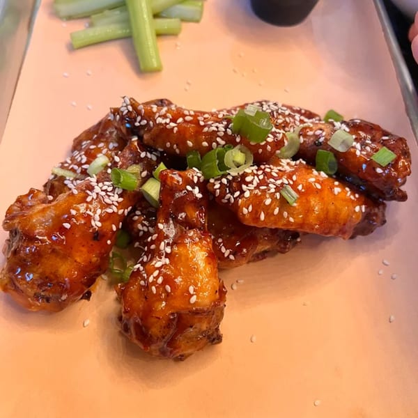 Runaway Train Brewery's sticky, sesame-crusted chicken wings with green onions and celery sticks.