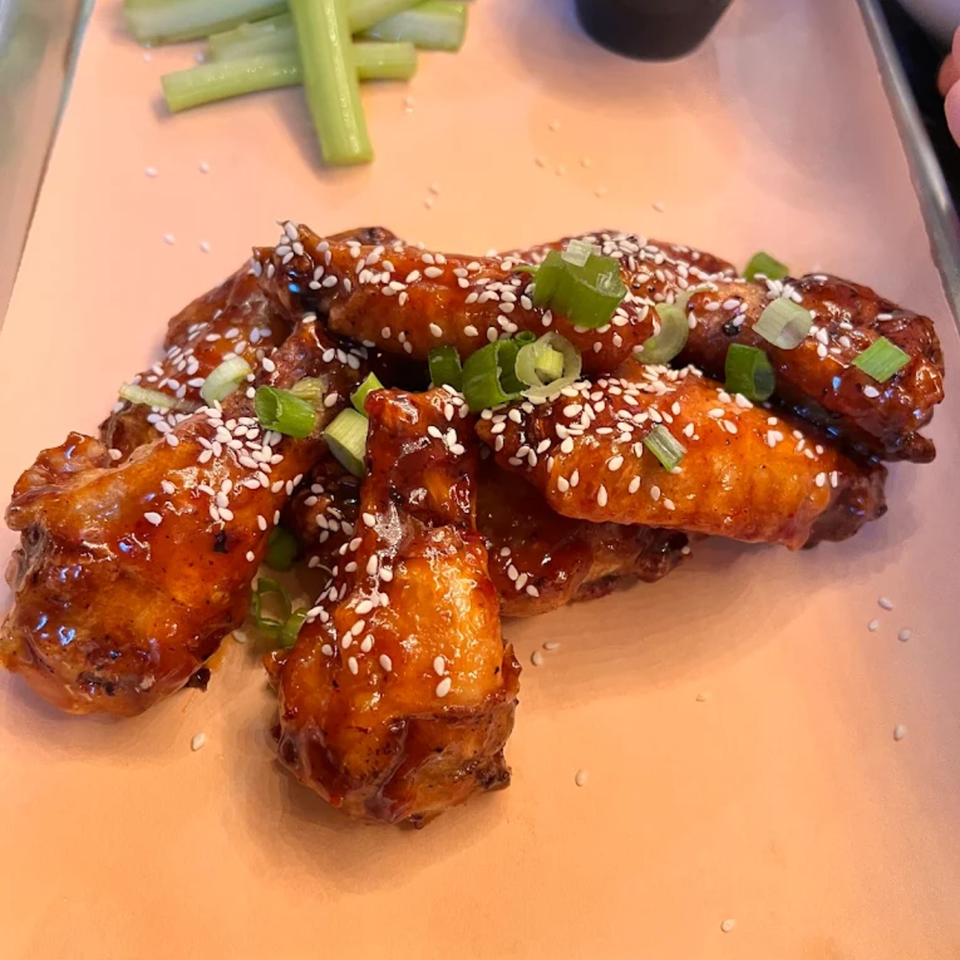 Runaway Train Brewery's sticky, sesame-crusted chicken wings with green onions and celery sticks.